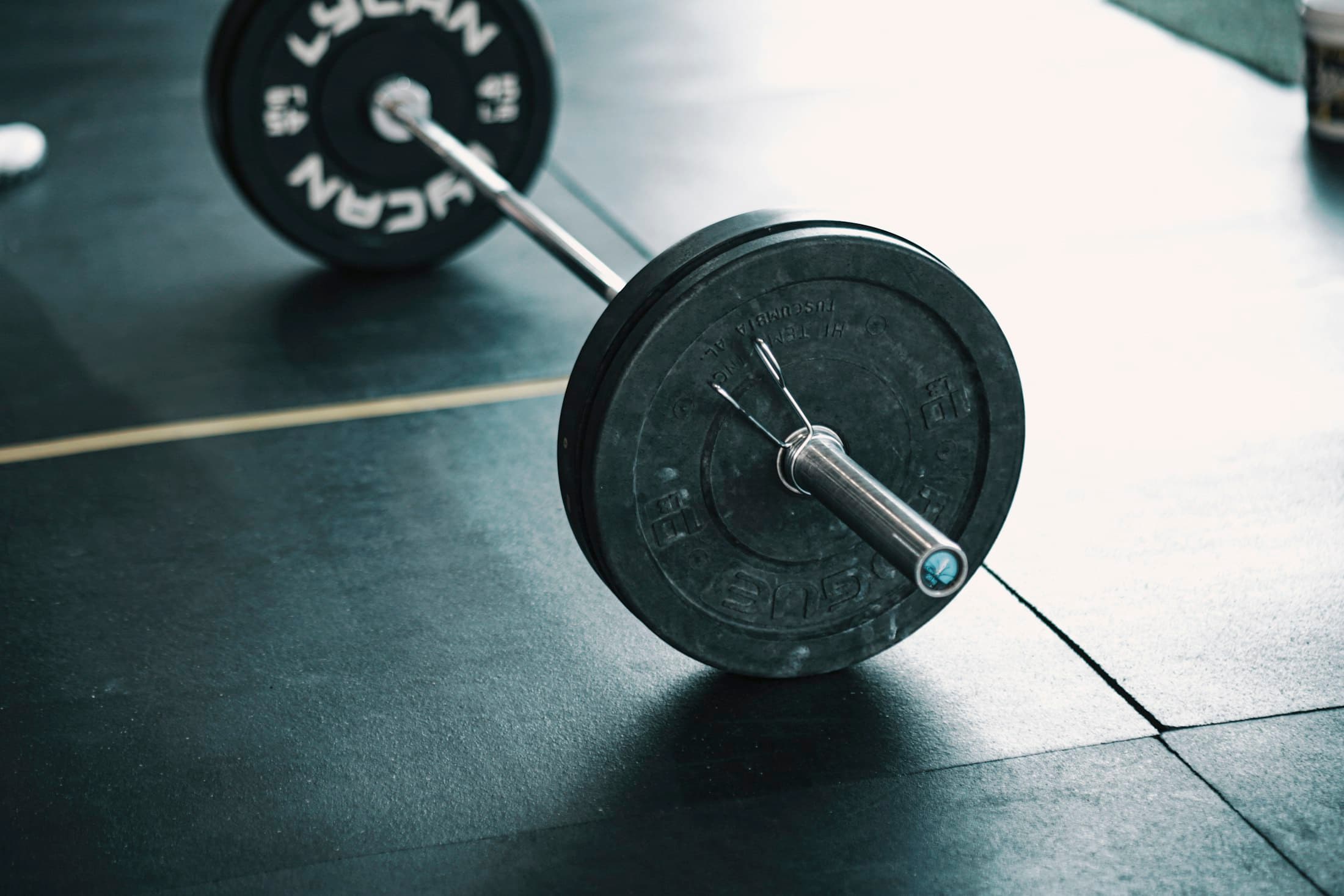 A loaded barbell resting on one of the platforms